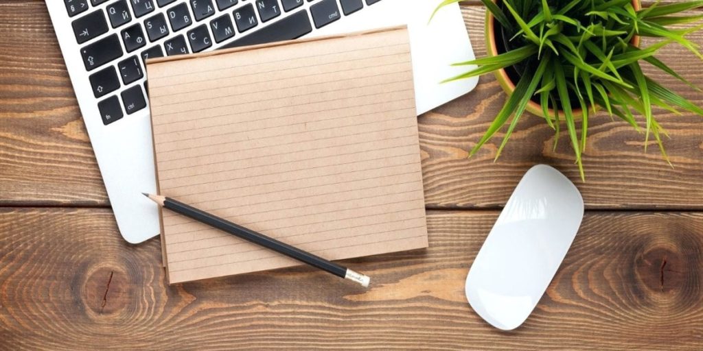top down image of laptop and notepad to take down NDIS Eligibility criteria
