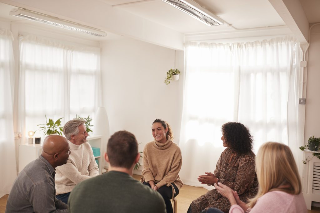 psychosocial disability support group in a bright white room with hanging plants