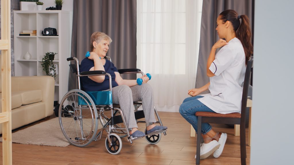 Old lady in wheelchair doing physical rehabilitation with nurse. Training, sport, recovery and lifting, old person retirement home, healthcare nursing, health support, social assistance, doctor and home service